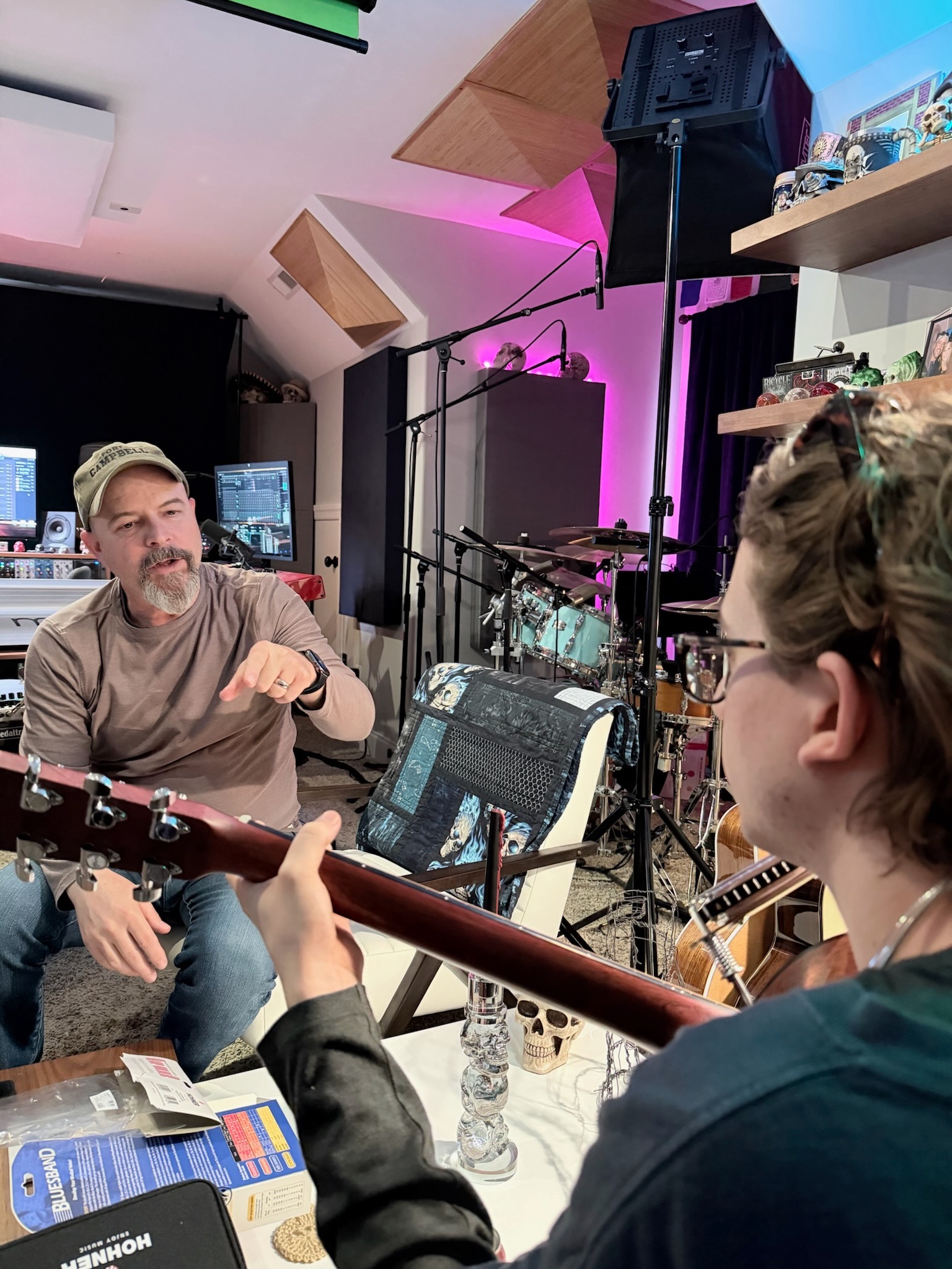 Two musicians discussing a guitar part inside Sweetflow Studio