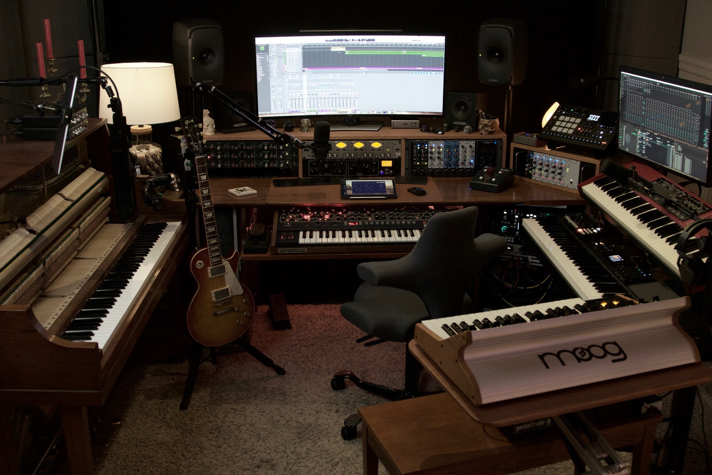 Wide view of the Sweetflow workstation surrounded by piano, guitars, synthesizers, and recording equipment