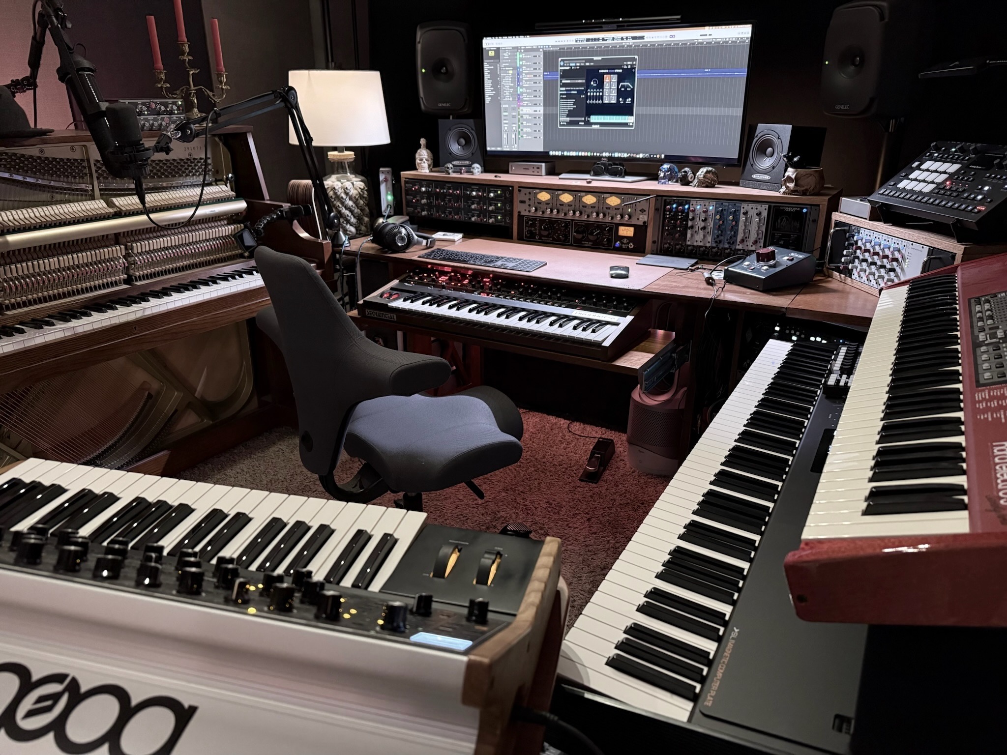 Current Sweetflow workstation framed by keyboards, upright piano, microphone, and outboard equipment